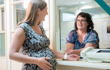 pregnant woman talking to clerk