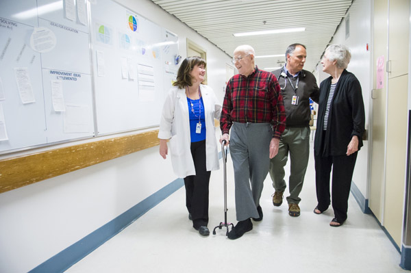 Geriatric healthcare team members with patient and family