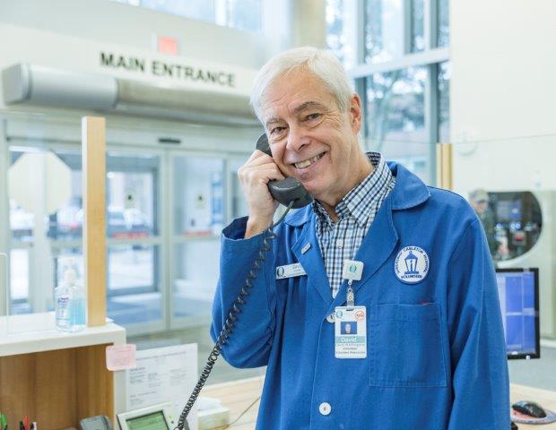 Volunteer answering the phone and smiling