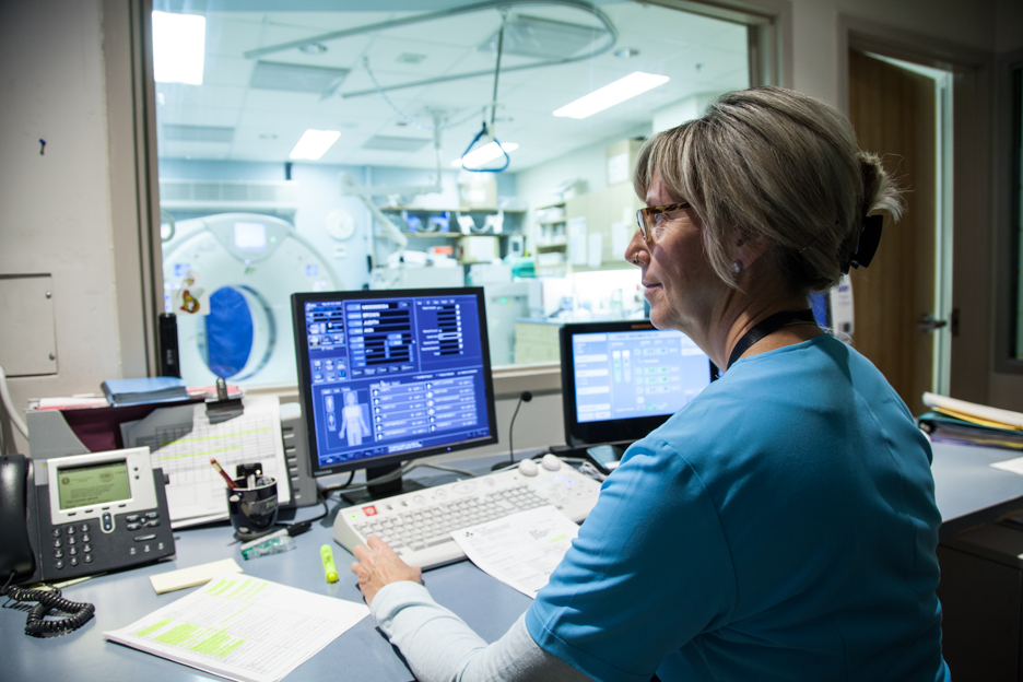 technician doing CT scan on patient